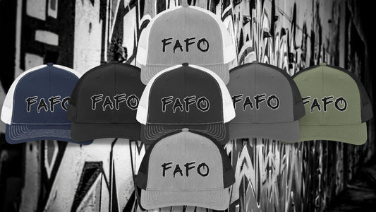 A collection of FAFO trucker hats in various color combinations, featuring bold embroidered lettering in a spray paint-style font, displayed against a graffiti-covered urban wall background.