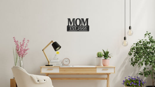 A personalized MOM steel sign reading "MOM EST. 2001" displayed on a stylish home office wall, adding a sentimental touch to the space.