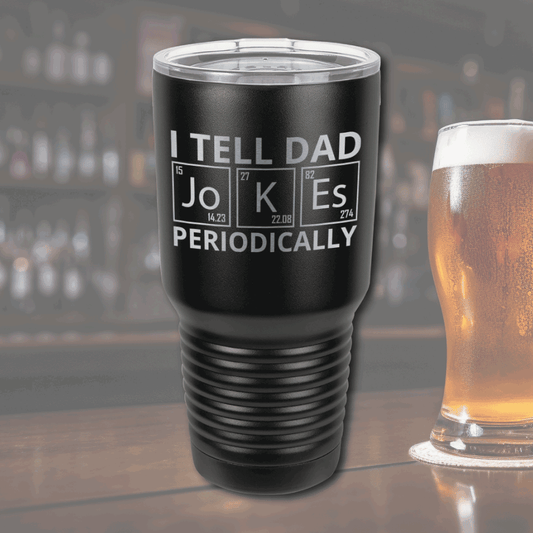 Dad Jokes 30oz Stainless Steel Tumbler: Black stainless steel 30oz tumbler with "I Tell Dad Jokes—Periodically" engraved design, sitting on a bar counter.