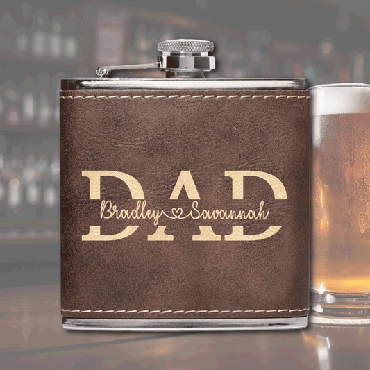 A premium stainless steel flask wrapped in a sleek leatherette cover, engraved with a custom name or message. Durable, stylish, and crafted with Amish precision.