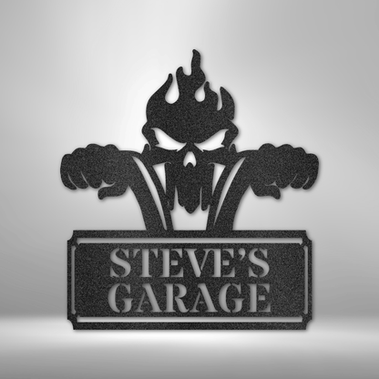 Custom steel garage sign featuring a flaming skull gripping ape hanger handlebars, with personalized nameplate. Precision-cut 16-gauge steel, powder-coated for durability, and available in Black, Silver, White, Copper, and Bronze finishes.