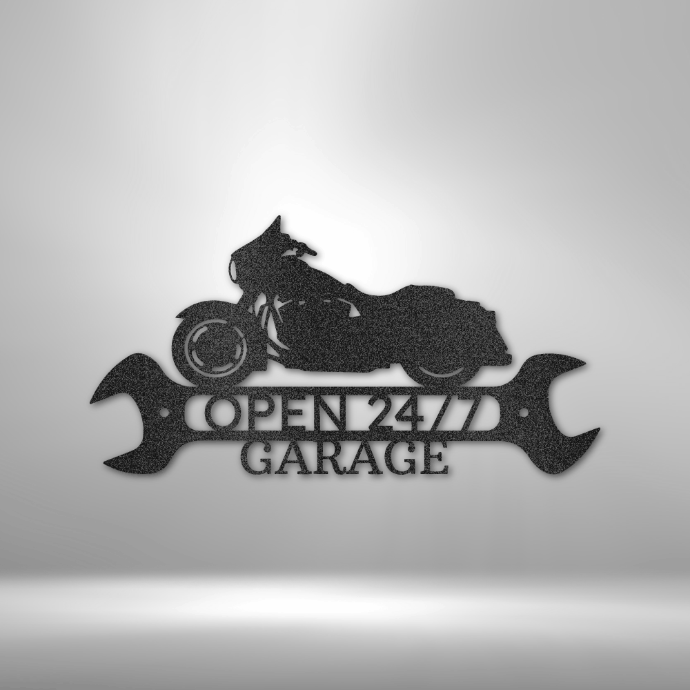 Custom Open 24/7 Garage metal sign featuring a bagger motorcycle silhouette and wrench backdrop. Durable 16-gauge steel with powder-coated finish.