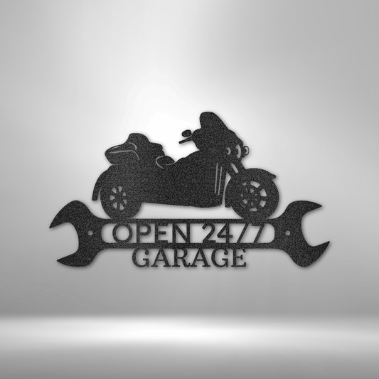 Black powder-coated steel sign featuring a touring motorcycle with "Open 24/7 Garage" text, flanked by two detailed wrenches.