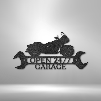 Open 24/7 Garage Steel Sign featuring a touring motorcycle silhouette atop two wrenches. Precision-cut from 16-gauge steel, powder-coated for durability, and available in Black, Silver, White, Copper, and Bronze finishes.