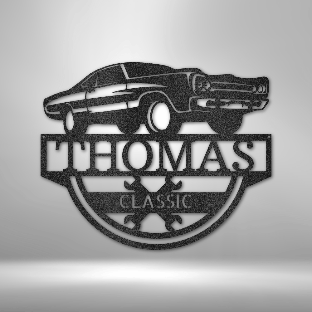 Customizable classic car metal sign featuring a vintage muscle car above a personalized nameplate with crossed wrenches. Crafted from 16-gauge steel with a durable powder-coated finish. Available in black, copper, bronze, silver, and white.