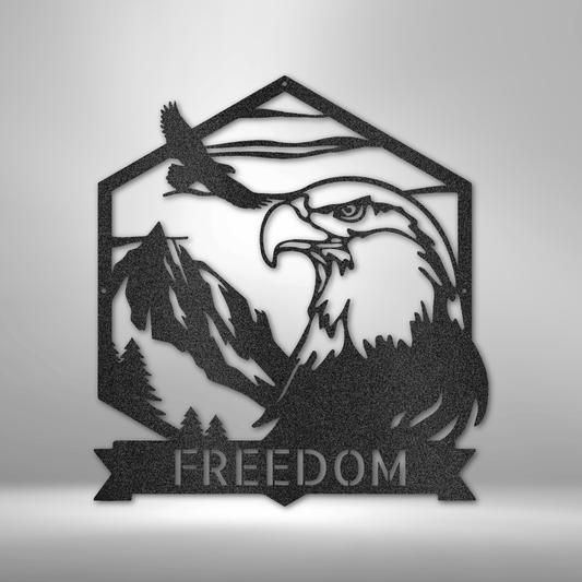 A 16-gauge steel sign featuring a detailed bald eagle with mountains and an American flag in the background, symbolizing freedom and patriotism. The sign is customizable and powder-coated for durability.