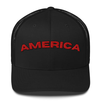 AMERICA arched trucker hat with red embroidered lettering on a patriotic snapback cap.